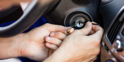 Person Inserting Tool In Key Hole